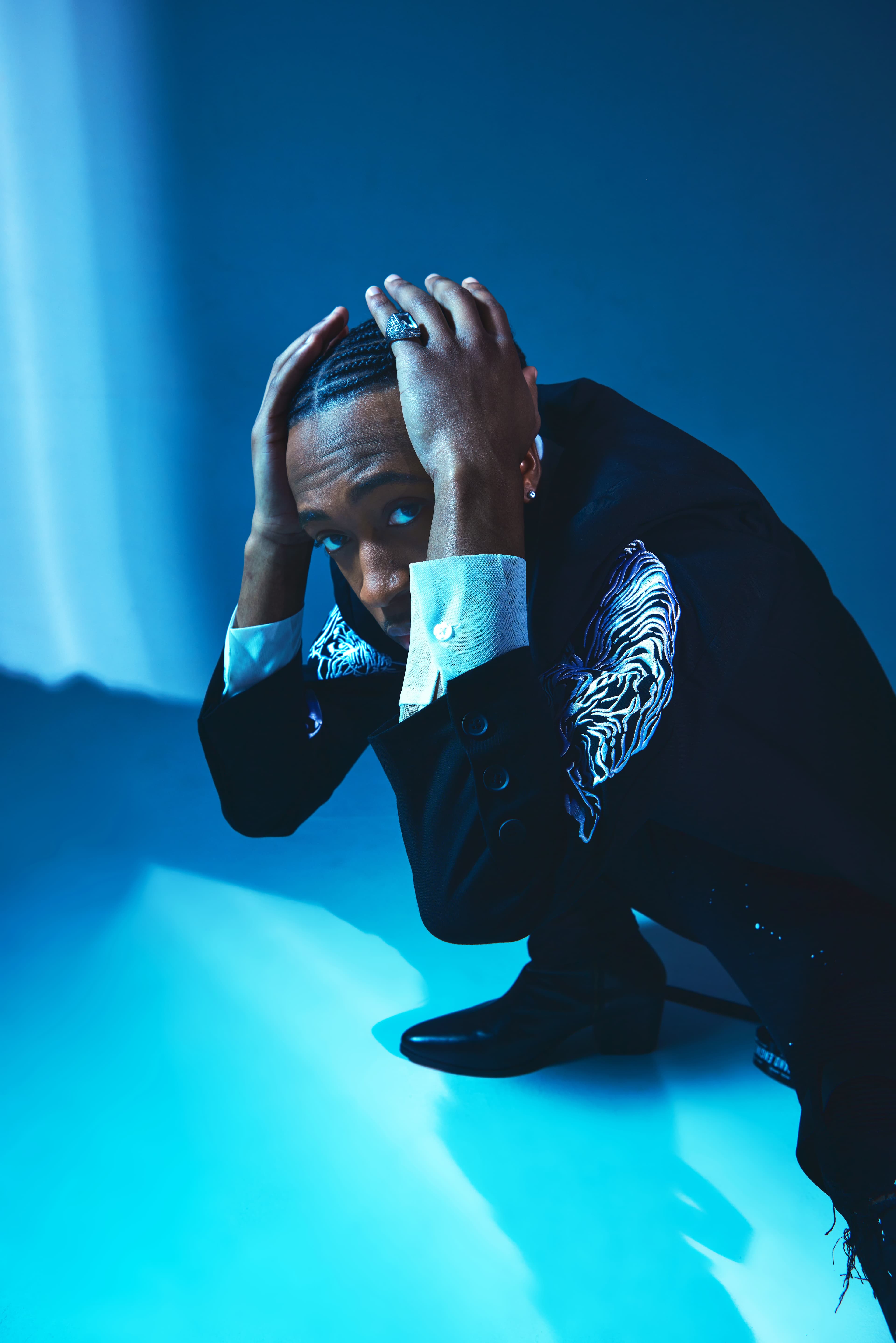 Blue cold-light crouched portrait